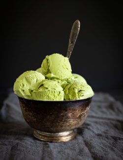 green tea ice cream with spoon in bowl