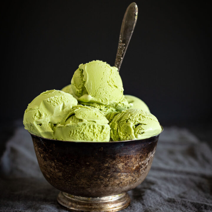 green tea ice cream with spoon in bowl