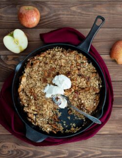 apple crisp with vanilla ice cream in a cast iron skillet