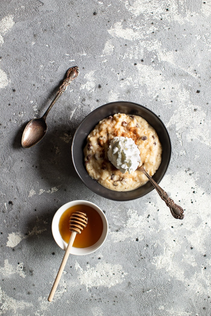 rice pudding with rasins, whipped cream, and honey