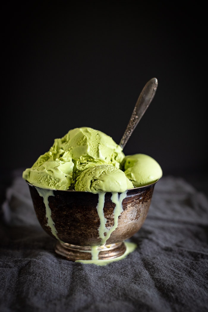 scoops of green tea ice cream in bowl with spoon