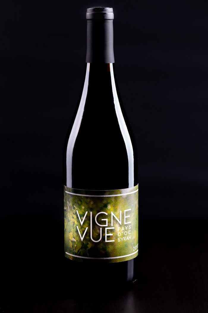 red wine bottle with black background