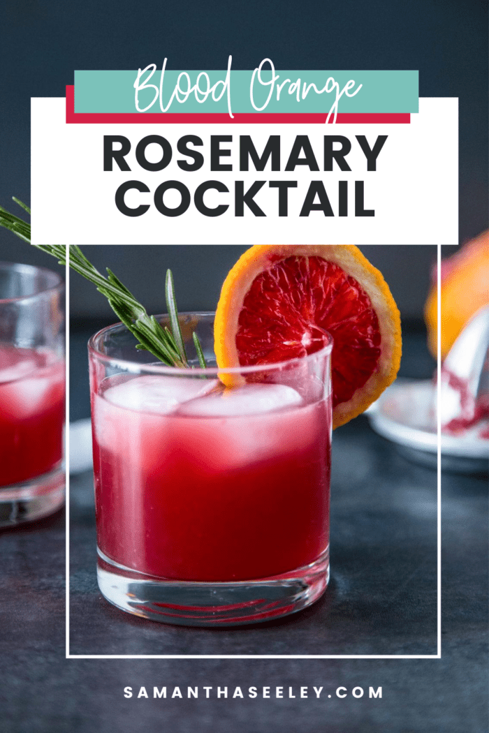 Pink cocktail with orange slice and rosemary