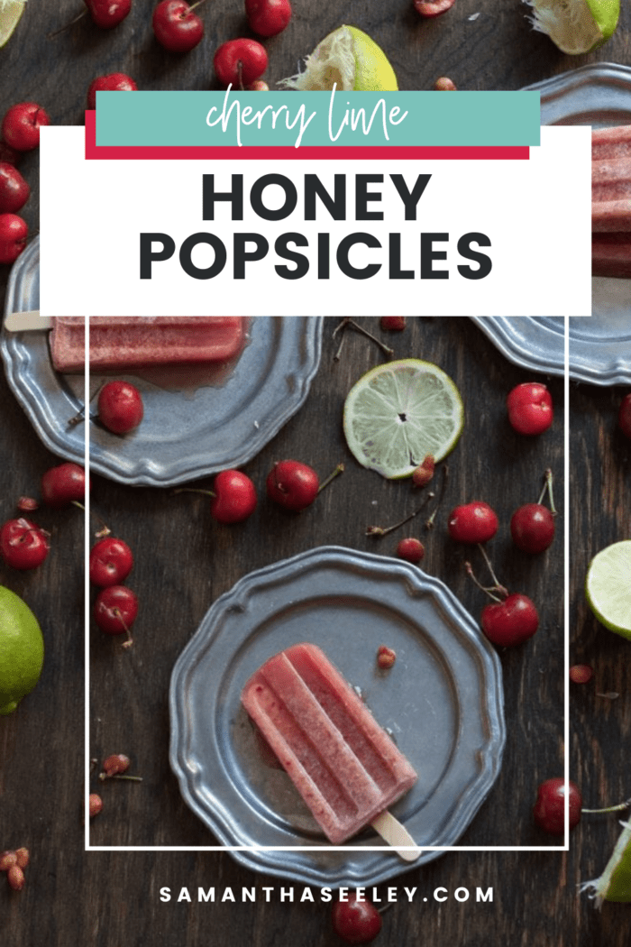 cherry lime popsicles on plates with cherries and limes